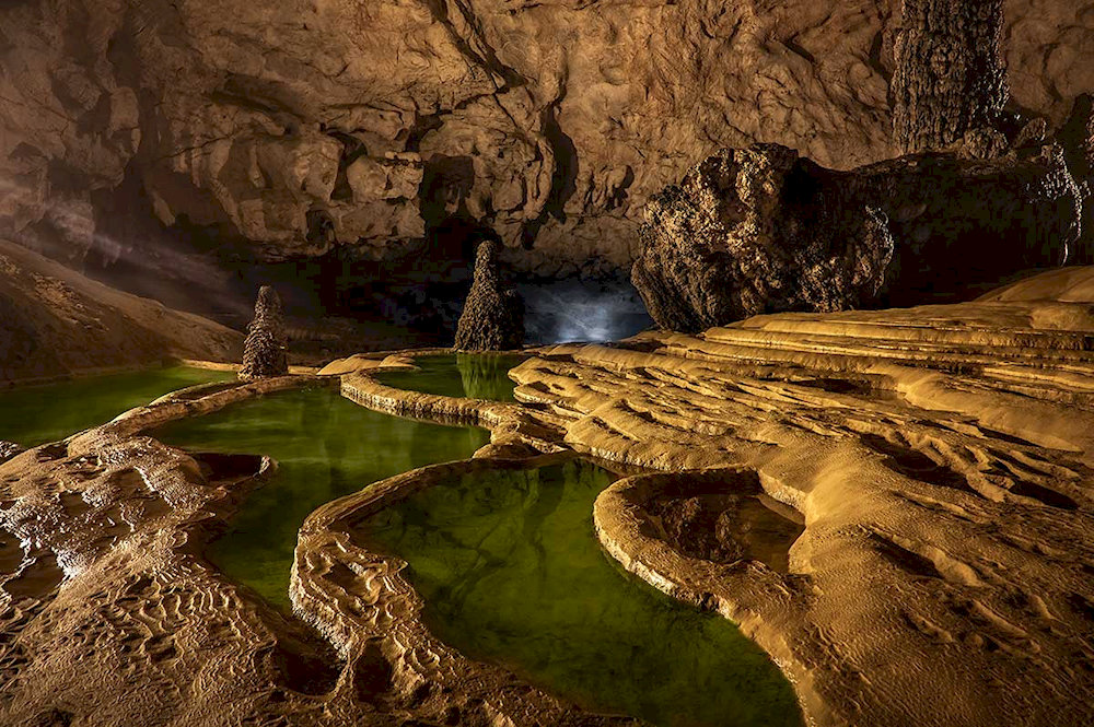 The vast underground chambers create a sense of awe, echoing with the quiet murmur of flowing water